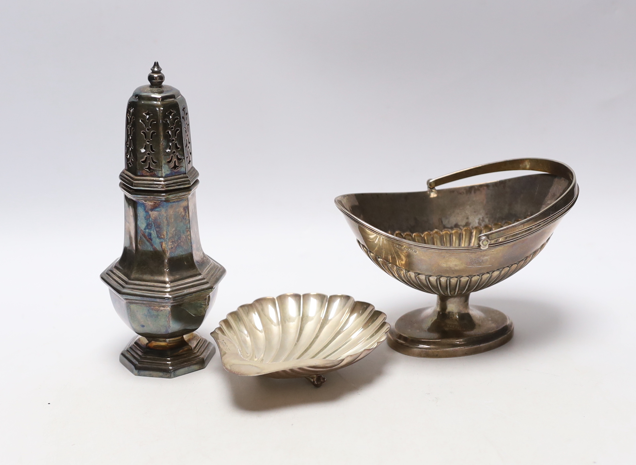 A modern silver sugar basket, London Assay Office marks for 1995 (cancelled earlier marks), an earlier silver butter shell and a sugar caster, 13.7oz.